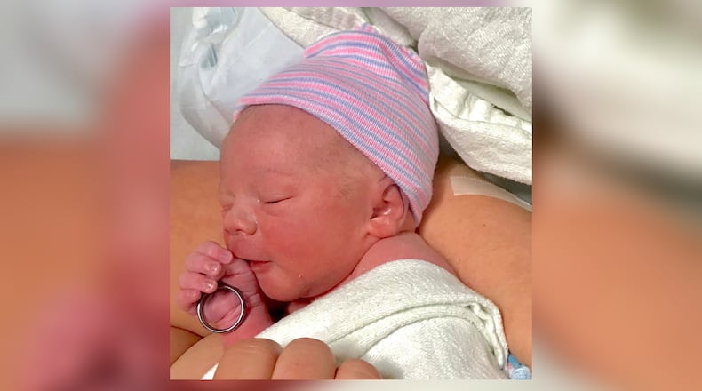 Bodie Allen Maddox, newborn son of slain officer Chase Maddox, holds his father's wedding ring. (Locust Grove Police Department)