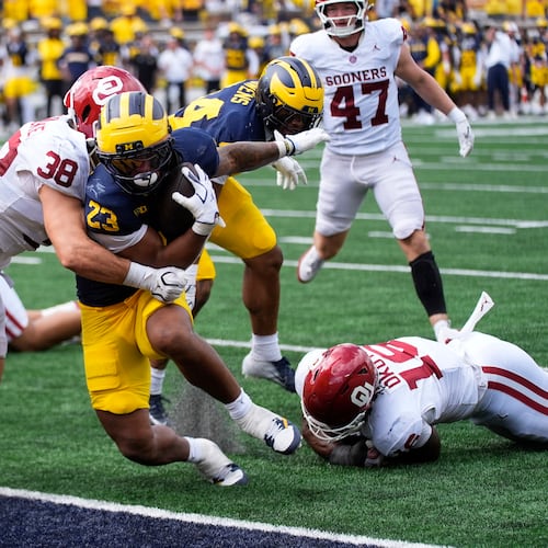 Michigan running back Jordan Marshall (23) scores a one-yard touchdown as Oklahoma linebacker Owen Heinecke (38) defends in the second half of an NCAA college football game Saturday, Sept. 12, 2026, in Ann Arbor, Mich. (AP Photo/Paul Sancya)
