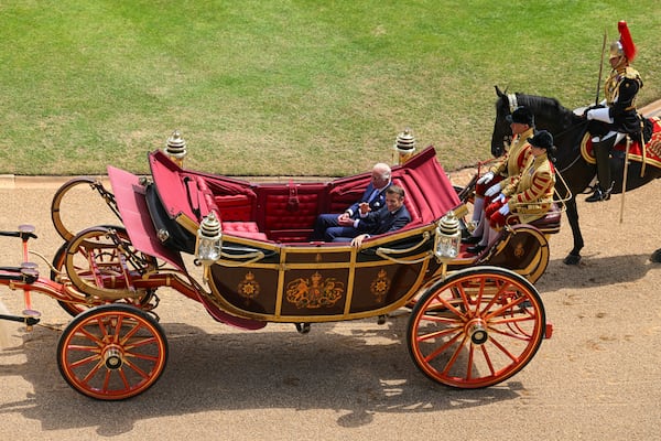 Britain's King Charles III, left, and French President Emmanuel Macron arrive at Windsor Castle in Windsor, England, Tuesday July 8, 2025, on the first day of a three-day state visit to Britain. (Jaimi Joy/Pool via AP)