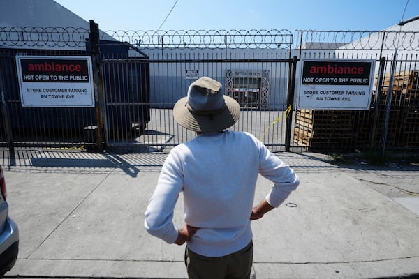 A man stands outside a business where federal immigration authorities conducted an operation on Friday, June 6, 2025, in Los Angeles. (AP Photo/Damian Dovarganes)