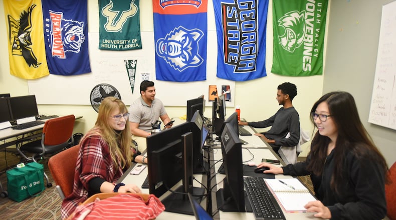 College student interns (from left) Alissa Beckett, from Kennesaw State University, Kasra Falahati, from Georgia State University, Gurmesa Shakme, from Georgia State University, and Esther Shin, from Georgia State University, work on their computers at InComm, a financial technology company, in Atlanta on Nov. 19, 2019. The interns are learning and utilizing communication skills at InComm. The University System of Georgia is working on revamping its core curriculum for the first time in two decades. The plan is to make it more flexible for 21st-century learning as more adults seek continuing education for their careers.