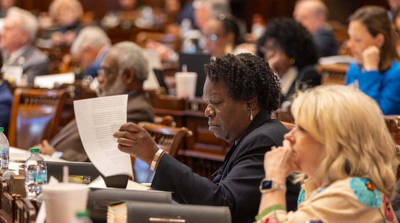 State Rep. Regina Lewis-Ward, a Democrat from McDonough, reviews a bill at the Capitol in Atlanta on Thursday. (Arvin Temkar/AJC)