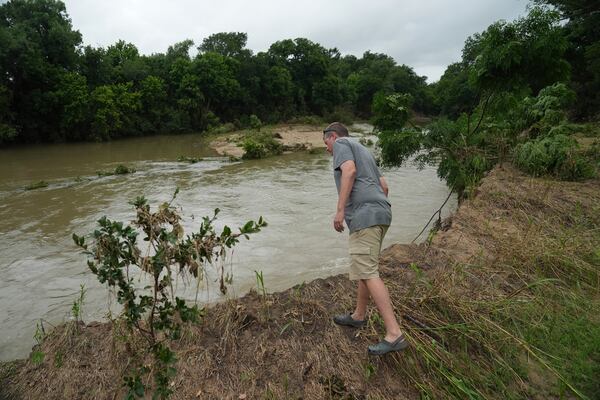 Jon Meredith, co-owner of Sweet Eats, looks over into the San Gabriel River following recent flooding Wednesday, July 9, 2025, near his farm in Georgetown, Texas. (AP Photo/Joshua A. Bickel)