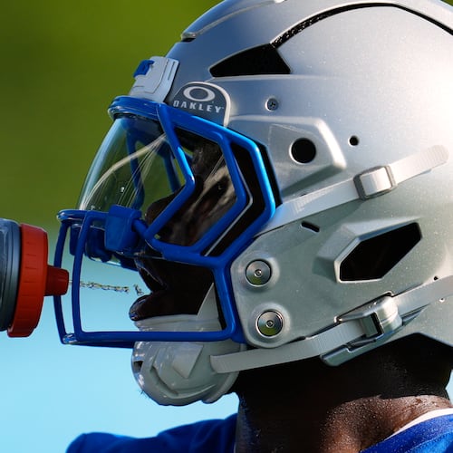 Detroit Lions running back Jabari Small drinks water to cool off from the heat during a NFL football training camp practice in Allen Park, Mich., Wednesday, July 29, 2026. (AP Photo/Paul Sancya)