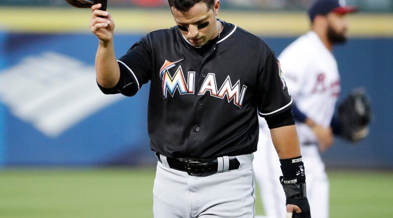 Miami Marlins' Martin Prado walks to the dugout after the first inning in which he hit a single to score teammate Dee Gordon in a baseball game against the Atlanta Braves in Atlanta, Wednesday, Sept. 14, 2016. (AP Photo/David Goldman)