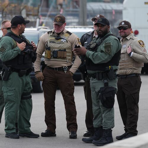 FILE - Law enforcement officers guard outside an ICE processing facility in the Chicago suburb of Broadview, Ill., on Nov. 21, 2025. (AP Photo/Nam Y. Huh, File)