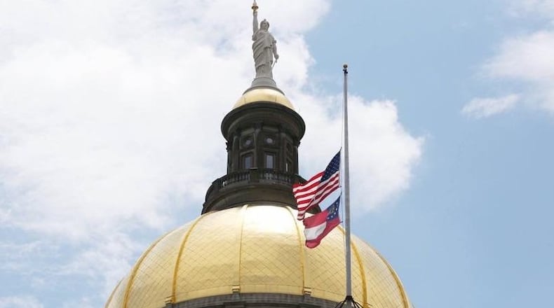 A flag flies at half-staff at the Gold Dome.