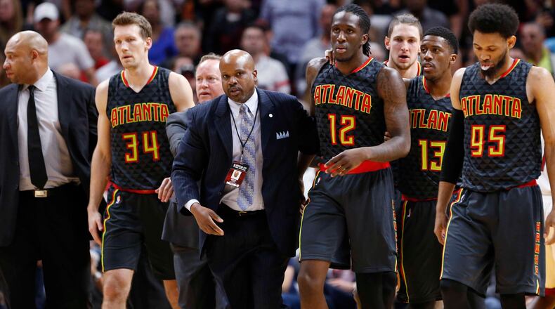 Atlanta Hawks forward Taurean Prince (12) is escorted away from a scuffle after Prince pulled down Miami Heat center Hassan Whiteside as Whiteside was going up for a shot during the second half of an NBA basketball game, Wednesday, Feb. 1, 2017, in Miami. Prince was ejected for pulling Whiteside down and was assessed a flagrant-2. James Johnson retaliated in Whiteside’s defense, and was ejected after getting a technical. The Heat defeated the Hawks 116-93. (AP Photo/Wilfredo Lee)
