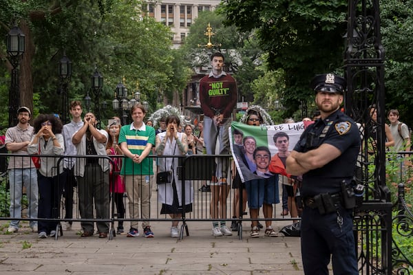 Protesters shout as New York Mayor Eric Adams speaks during a campaign launch rally at City Hall, Thursday, June. 26, 2025, in New York. (AP Photo/Yuki Iwamura)