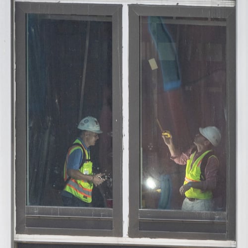People inspect a buckled support beam inside 235 East 42nd Street, Wednesday, July 8, 2026, in New York. (AP Photo/Yuki Iwamura)