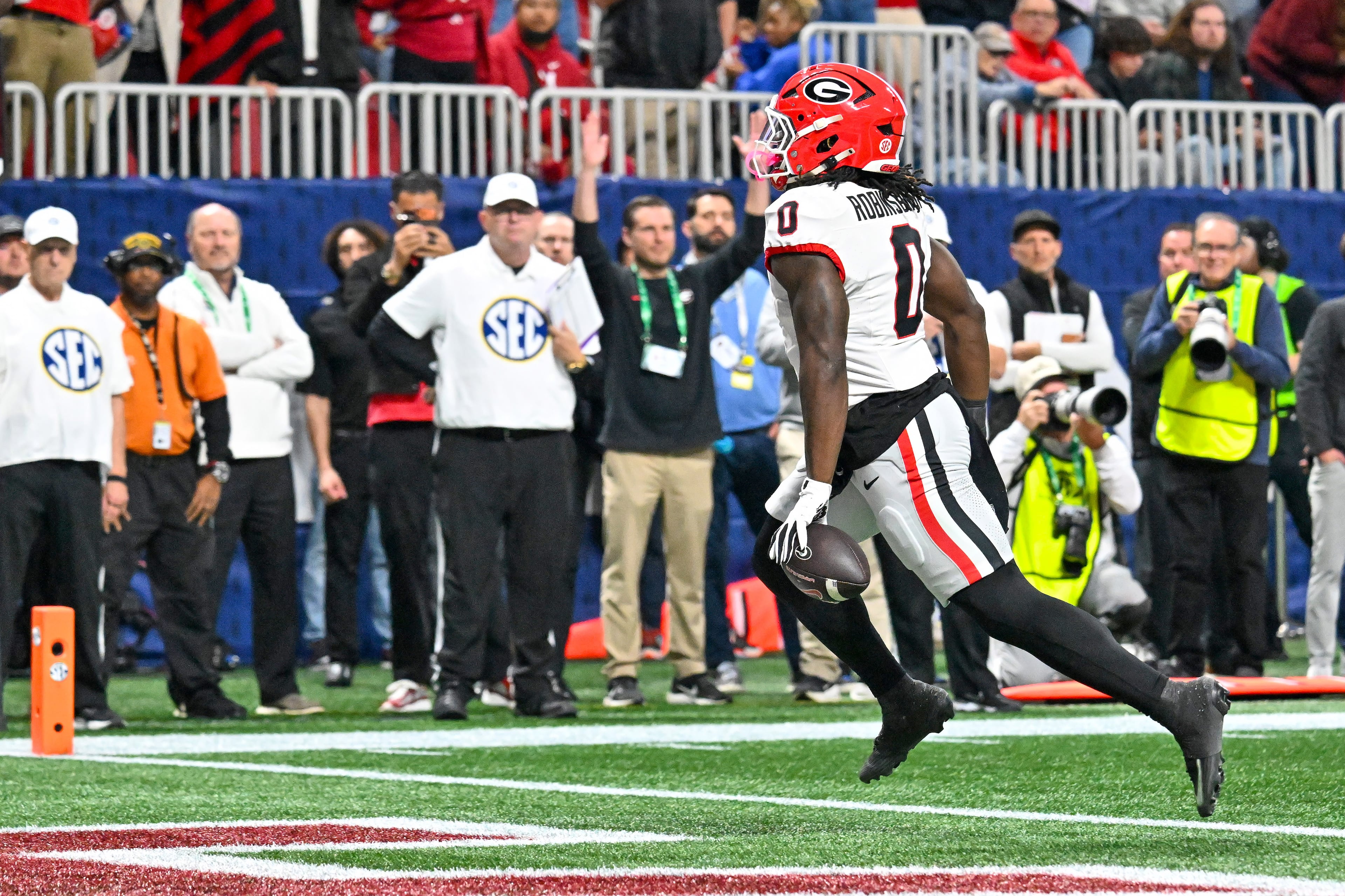 Georgia running back Roderick Robinson II (0) scores the game's first touchdown on a short run past the Alabama defense during the first quarter of the SEC Championship game at Mercedes-Benz Stadium, Saturday, Dec. 6, 2025, in Atlanta. (Hyosub Shin / AJC)