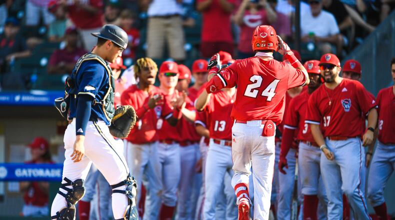 N.C. State's Luca Tresh reaches home past Georgia Tech catcher Kevin Parada after his fourth-inning home run in the Wolfpack's 8-1 win in an ACC Tournament semifinal May 29, 2021 at Truist Field in Charlotte, N.C. (Laura Wolff/ACC)