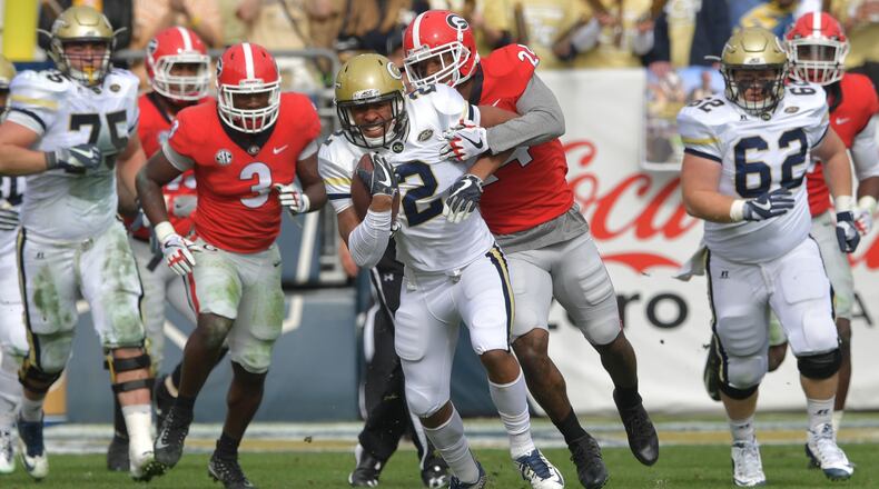 November 25, 2017 Atlanta - Georgia Tech wide receiver Ricky Jeune (2) eludes a tackle by Georgia safety Dominick Sanders (24) in the first half of an NCAA college football game at Bobby Dodd Stadium on Saturday, November 25, 2017. HYOSUB SHIN / HSHIN@AJC.COM