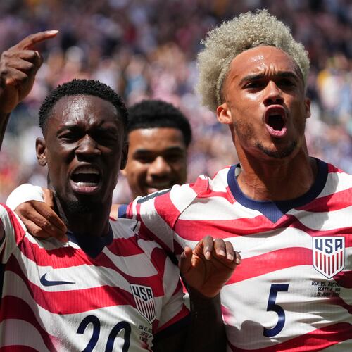 United States' Folarin Balogun (20) and Antonee Robinson (5) celebrate after scoring during the World Cup Group D soccer match between the United States and Australia in Seattle, Friday, June 19, 2026. (AP Photo/Ted S. Warren)