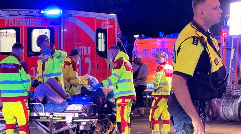 Emergency personnel tend to a person on a stretcher following the cancellation of Christopher Street Day in Berlin on Saturday, July 25, 2026. (Andreas Rabenstein/dpa via AP)