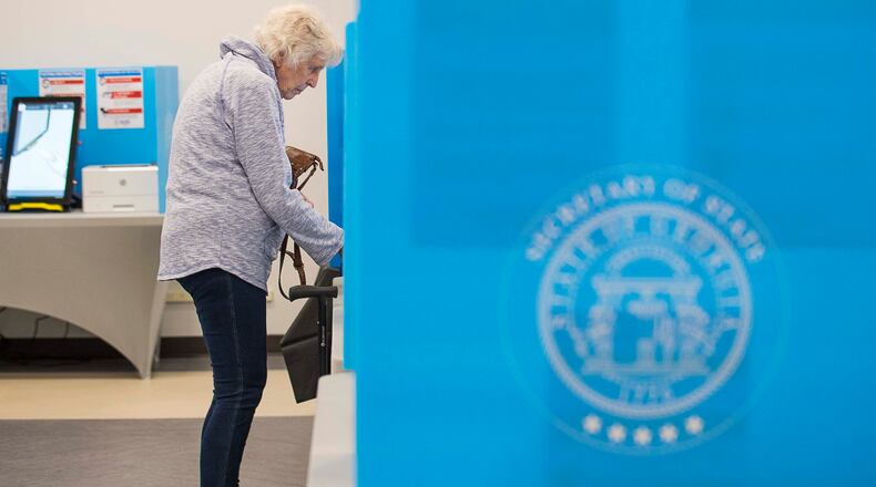03/02/2020 -- Lawrenceville, Georgia -- A voter uses the new electronic voting system to lock in her vote during early voting for the presidential primary at the Gwinnett Voter Registrations and Elections office building in Lawrenceville, Monday, March 2, 2020. (ALYSSA POINTER/ALYSSA.POINTER@AJC.COM)