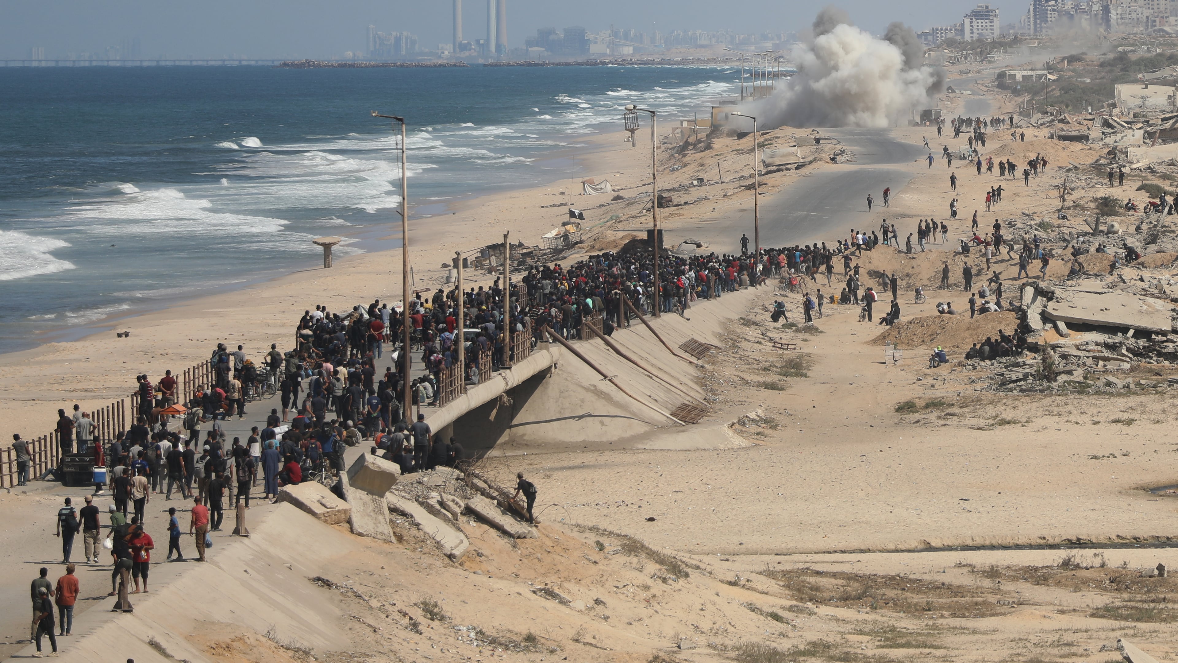 Displaced Palestinians walk along the coastal road near Wadi Gaza in the central Gaza Strip, moving toward northern Gaza, Friday, Oct. 10, 2025, after Israel and Hamas have agreed to a pause in their war and the release of the remaining hostages. (AP Photo/Yousef Al Zanoun)