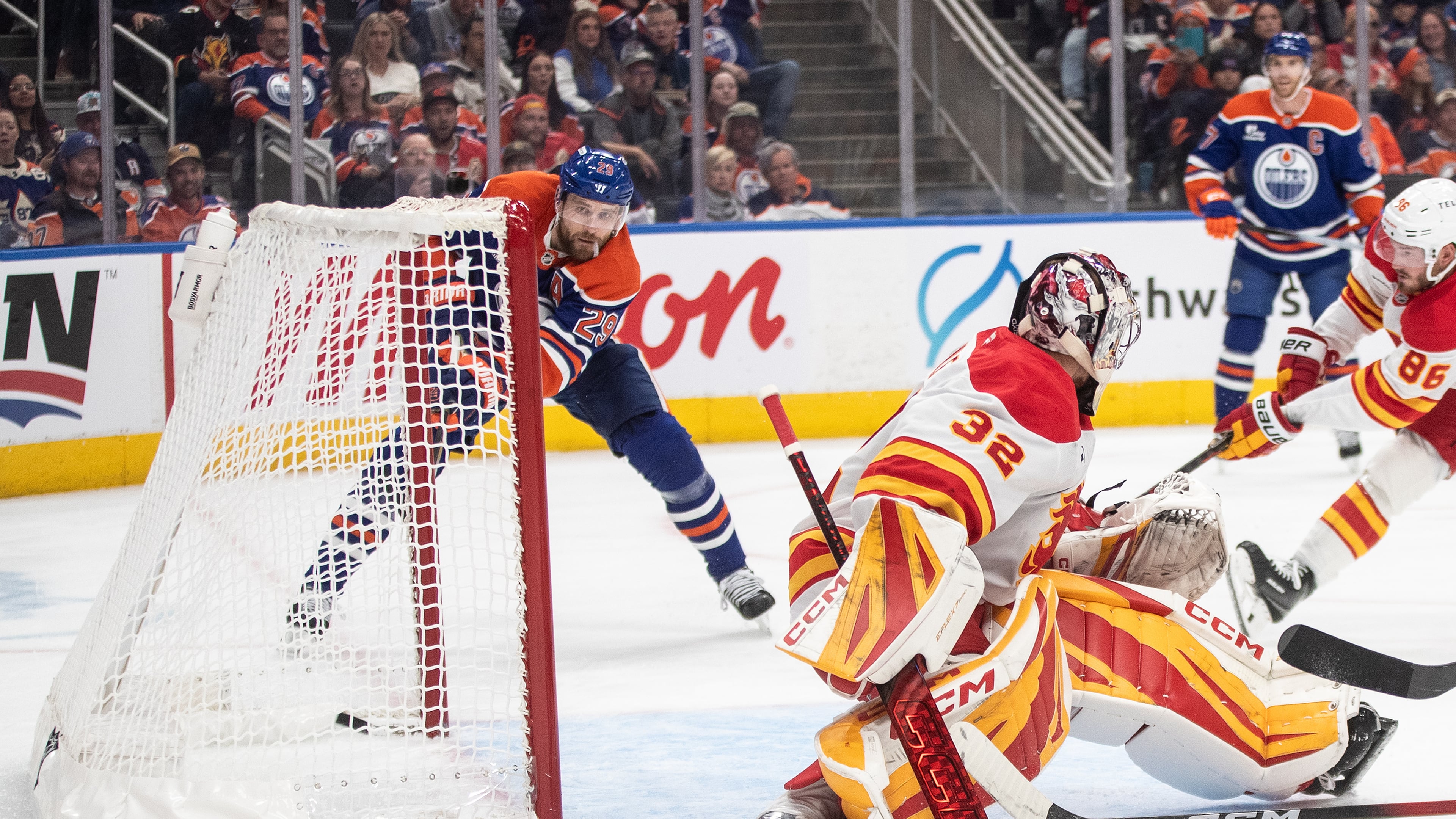 Edmonton Oilers' Leon Draisaitl (29) scores his 400th career goal against Calgary Flames goalie Dustin Wolf (32) during second period NHL action, in Edmonton on Wednesday, Oct. 8, 2025. (Jason Franson/The Canadian Press via AP)