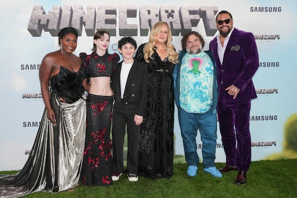 Danielle Brooks, from left, Emma Myers, Sebastian Hansen, Jennifer Coolidge, Jack Black and Jason Momoa pose for photographers upon arrival at the World premiere of A Minecraft Movie on Sunday, March 30, 2025, in London. (Photo by Scott A Garfitt/Invision/AP)
