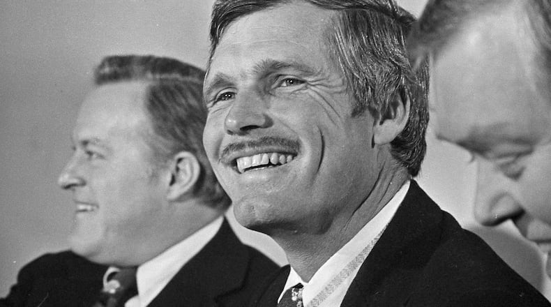 Ted Turner, Atlanta advertising and television executive, smiles after it was announced that he purchased the Atlanta Braves, Jan. 6, 1976, in Atlanta. Purchase price for the team was not disclosed but it was reportedly in the $10 million range. Turner is flanked by club chairman Bill Bartholomay, left, and president Dan Donahue. (AP Photo/Charles E. Kelly)