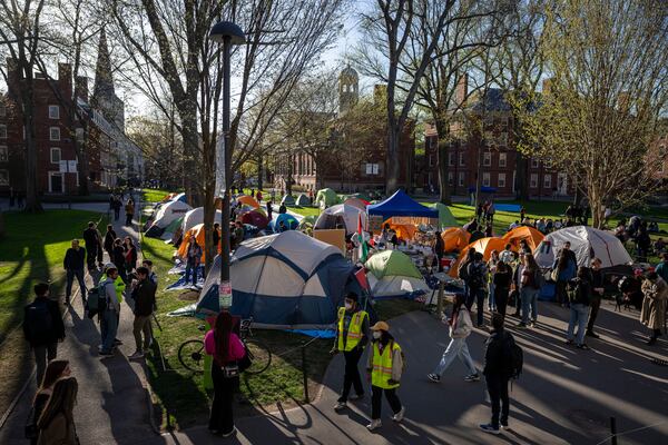 FILE - Students protesting against the war in Gaza, and passersby walking through Harvard Yard, are seen at an encampment at Harvard University in Cambridge, Mass., on April 25, 2024. (AP Photo/Ben Curtis, File)