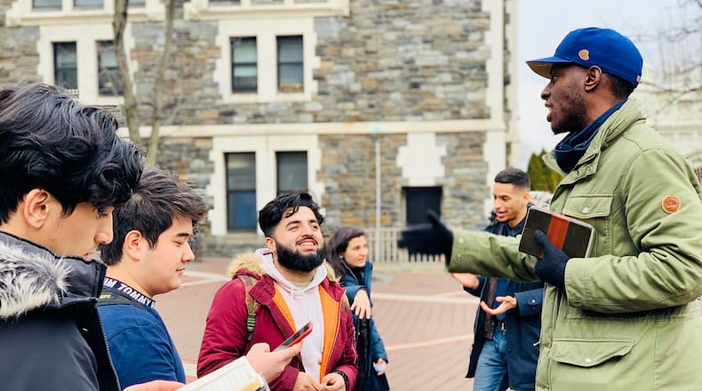 Chike Uzuegbunam (on the right in the blue hat) filed a federal lawsuit against Georgia Gwinnett College in 2016, arguing his free speech rights were violated after he was stopped from handing out religious flyers and talking to students about his faith. Now, the U.S. Supreme Court will decide whether he is entitled to nominal damages. CONTRIBUTED
