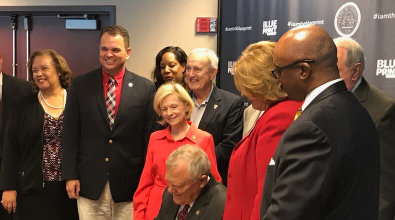 Gov. Nathan Deal signs the fiscal 2018 state budget in Atlanta. JAMES SALZER/JSALZER.AJC.COM