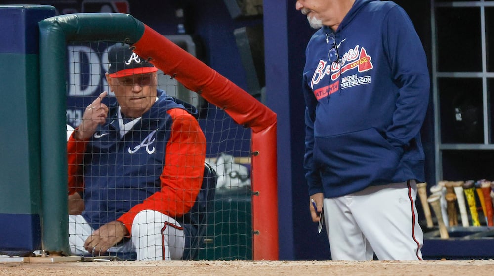 Atlanta Braves manager Brian Snitker and pitching coach Rick Kranitz confer during the fourth inning of NLDS Game 2 against the Philadelphia Phillies in Atlanta on Monday, Oct. 9, 2023. (Miguel Martinez/AJC)