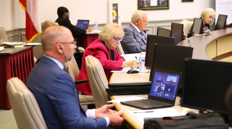 Board member Steve Knudsen (from left), chair Louise Radloff, and chief executive officer J. Alvin Wilbanks practice social distancing while the Gwinnett County Board of Education, the largest school district in the state, conducts its first work session and budget meeting in cyberspace at the Gwinnett County Public Schools Instructional Support Center in Suwanee. Radloff lost her reelection bid. Curtis Compton ccompton@ajc.com AJC FILE PHOTO