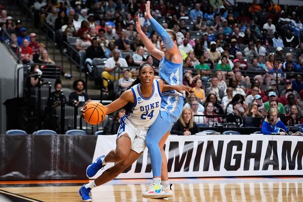 Duke guard Reigan Richardson (24) drives around North Carolina guard Lexi Donarski during the second half in the Sweet 16 of the NCAA college basketball tournament, Friday, March 28, 2025, in Birmingham, Ala. (AP Photo/Gerald Herbert)