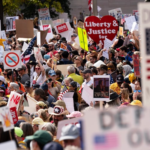 FILE - Demonstrators rally on Pennsylvania Avenue during a No Kings protest in Washington, Oct. 18, 2025. (AP Photo/Jose Luis Magana, File)