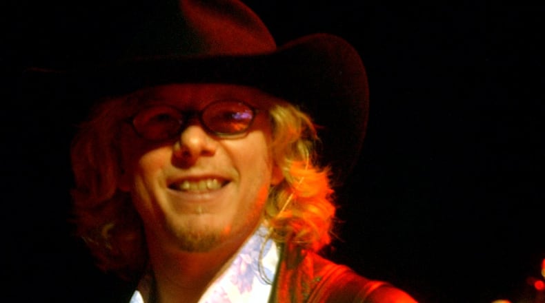 031011 - ATLANTA - R.E.M. bassist Mike Mills smiles during during the band's homecoming show Saturday night 10/11/03 at Philips Arena in Atlanta. (PHOTO BY CELINE BUFKIN/STAFF)