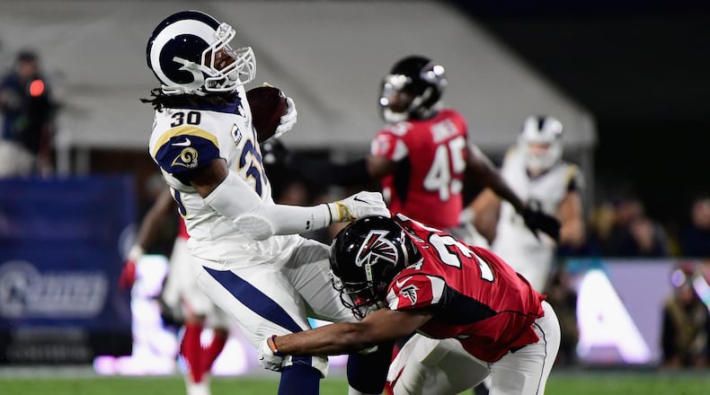 LOS ANGELES, CA - JANUARY 06: Running back Todd Gurley #30 of the Los Angeles Rams is tackled by cornerback Brian Poole #34 of the Atlanta Falcons during the first quarter of the NFC Wild Card Playoff game at Los Angeles Coliseum on January 6, 2018 in Los Angeles, California. (Photo by Harry How/Getty Images)