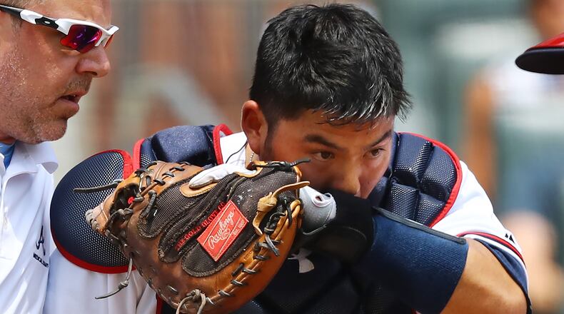 Atlanta Braves catcher Kurt Suzuki leaves the game after getting hit in the head with a bat by San Diego Padres Raffy Lopez during the second inning in a MLB baseball game on Sunday, June 17, 2018, in Atlanta.  Curtis Compton/ccompton@ajc.com
