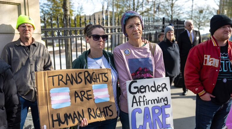 Pam Miller and Maha Taylor attend a rally against SB 140 outside the Capitol in Atlanta on Monday, March 20, 2023. SB 140 would prevent medical professionals from giving transgender children certain hormones or surgical treatment. (Arvin Temkar / arvin.temkar@ajc.com)