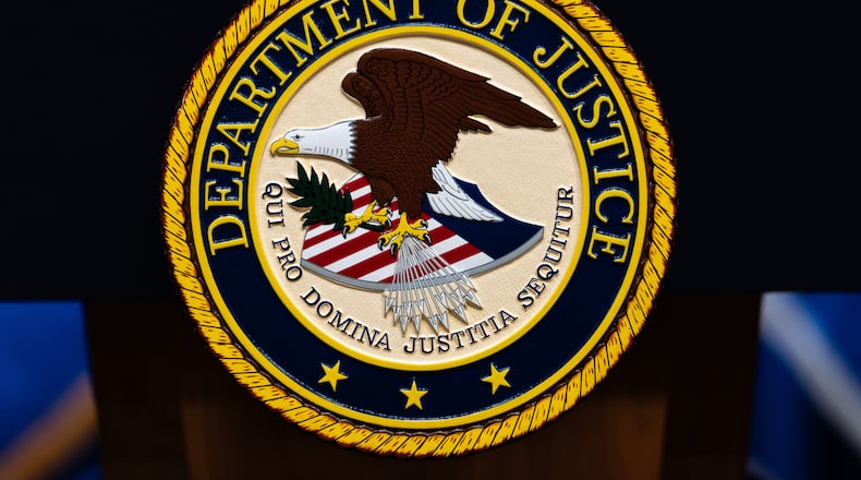 FILE - The U.S. Department of Justice logo is seen on a podium before a news conference, May 4, 2026, in Washington. (AP Photo/Julia Demaree Nikhinson, File)