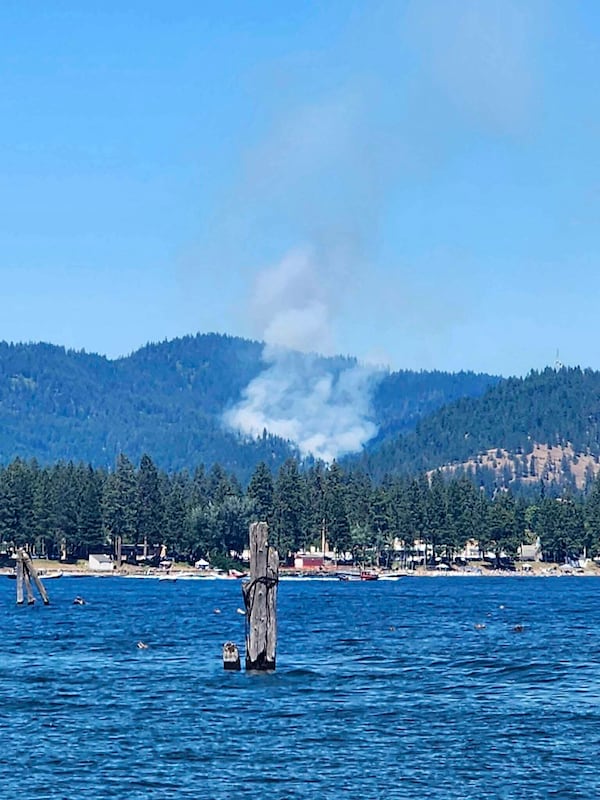 Smoke rises from a fire near Coeur d'Alene, Idaho, where responding firefighters were shot on Sunday, June 29, 2025. (Bruce Deming via AP)
