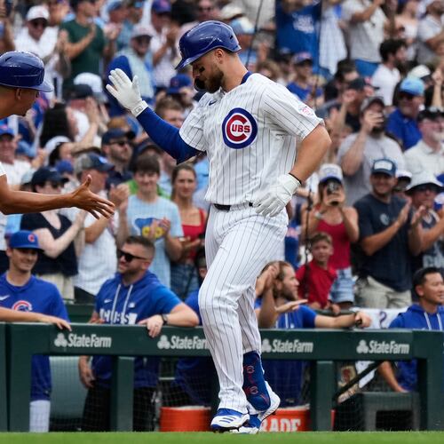 Chicago Cubs' Michael Busch, right, celebrates with third base coach Quintin Berry after hitting a solo home run during the first inning of a baseball game against the Minnesota Twins in Chicago, Saturday, July 18, 2026. (AP Photo/Nam Y. Huh)