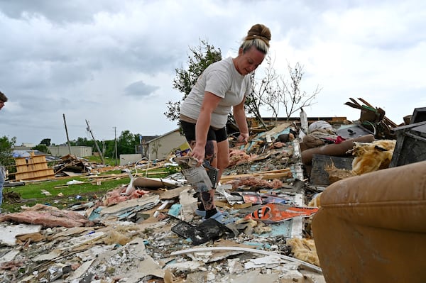 Angela Lewis goes through the remains of a house that was destroyed by severe weather in the Sunshine Hills neighborhood in London, Ky., Monday, May 19, 2025. (AP Photo/Timothy D. Easley)