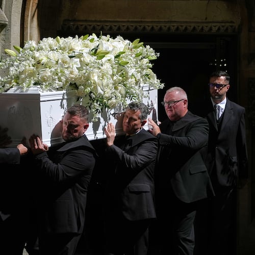 The coffin is taken from Swansea Minster following the funeral of Bonnie Tyler in Swansea, Wales, Monday, Aug. 17, 2026. (AP Photo/Alastair Grant)
