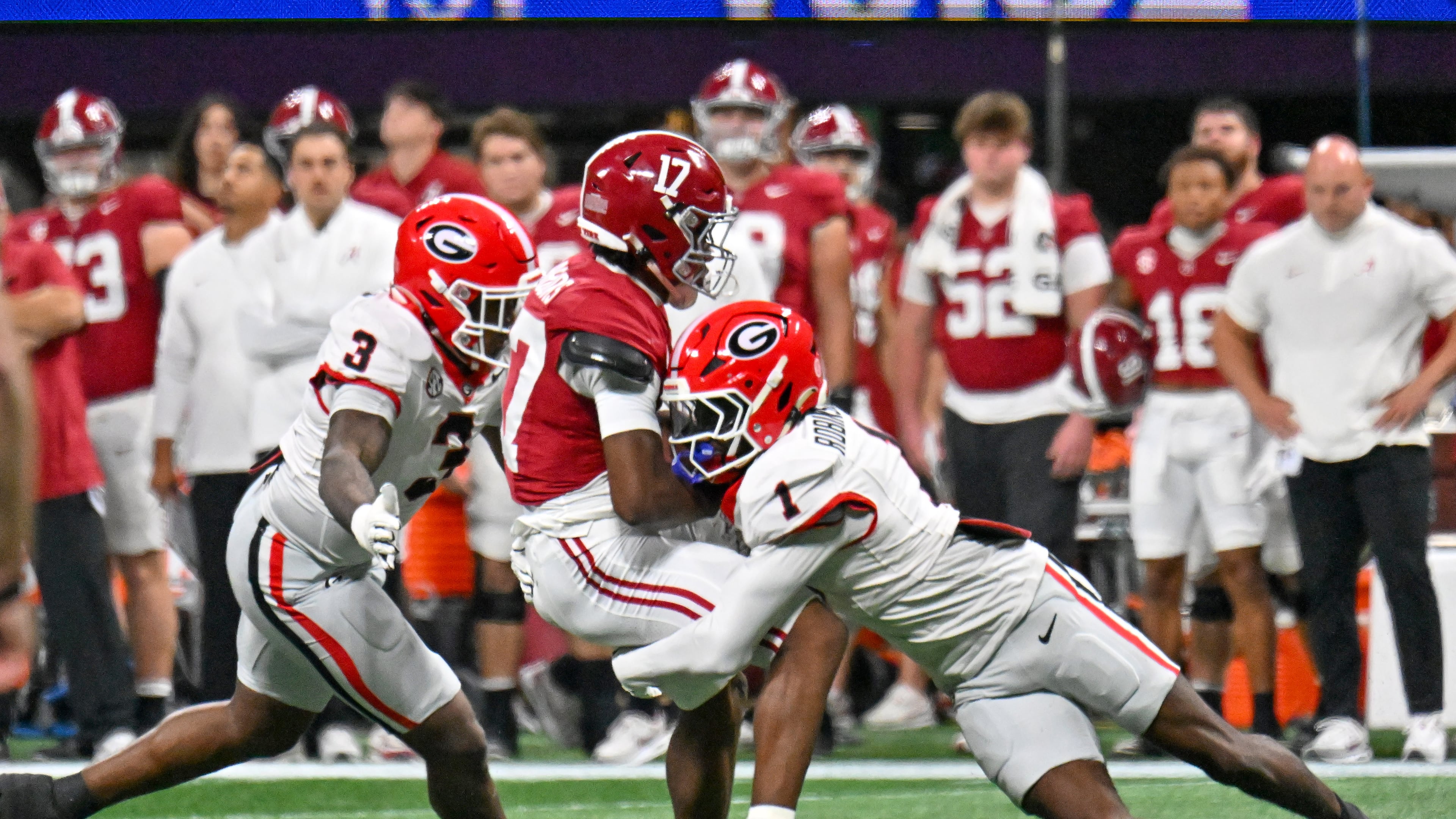 Alabama wide receiver Lotzeir Brooks is stopped by Georgia linebacker CJ Allen and defensive back Ellis Robinson IV during the first quarter of the SEC Championship game at Mercedes-Benz Stadium, Saturday, Dec. 6, 2025, in Atlanta. (Hyosub Shin/AJC)