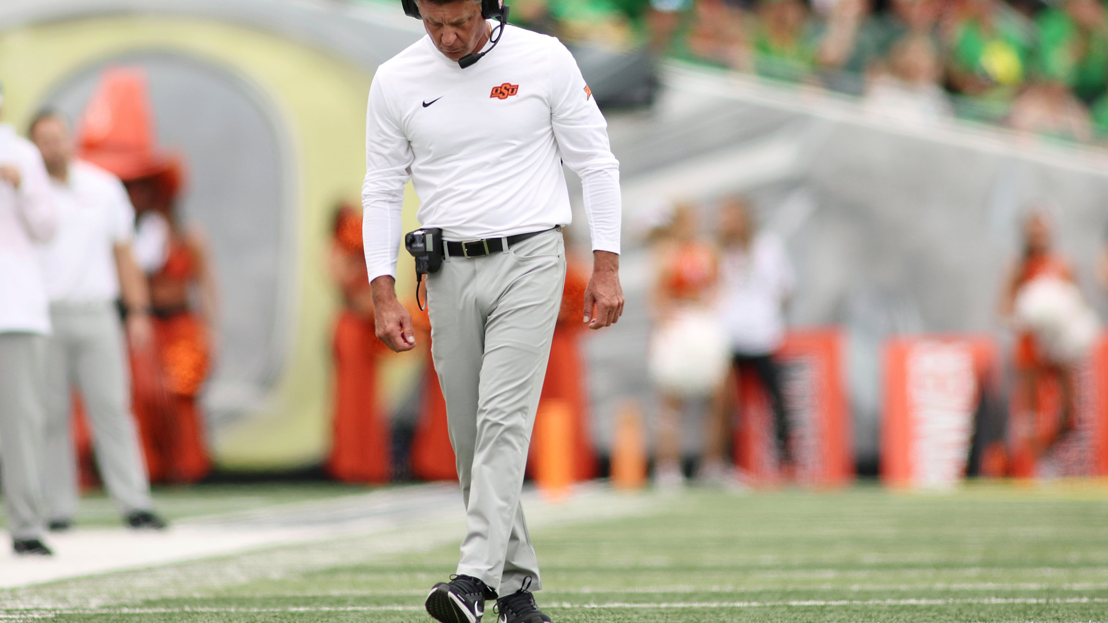 Oklahoma State head coach Mike Gundy walks on the field during the first half of an NCAA college football game, Saturday, Sept. 6, 2025, in Eugene, Ore. (AP Photo/Lydia Ely)