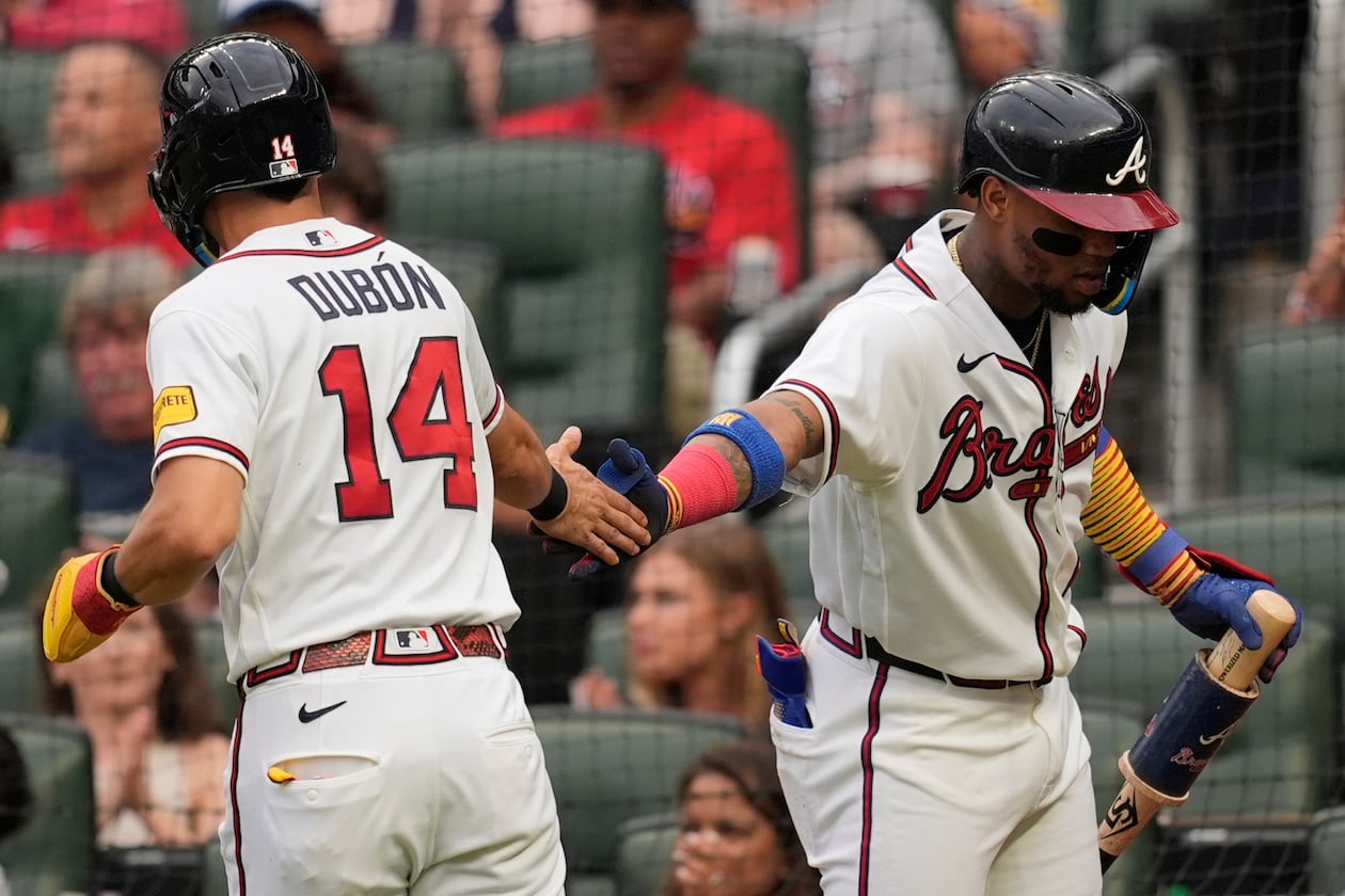 Atlanta Braves' Mauricio Dubón (14) celebrates scoring off the bat of Drake Baldwin in the second inning of a baseball game against the Miami Marlins, Wednesday, Aug. 5, 2026, in Atlanta. (Mike Stewart/AP)