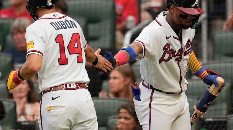 Atlanta Braves' Mauricio Dubón (14) celebrates scoring off the bat of Drake Baldwin in the second inning of a baseball game against the Miami Marlins, Wednesday, Aug. 5, 2026, in Atlanta. (Mike Stewart/AP)