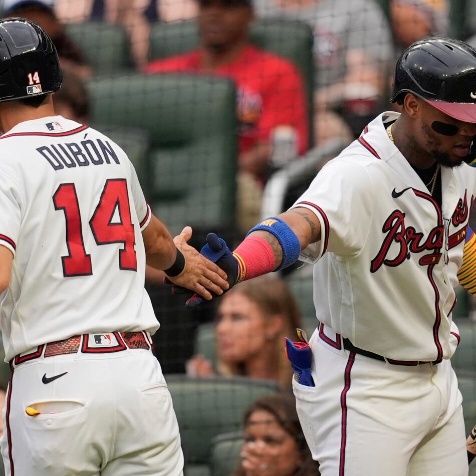 Atlanta Braves' Mauricio Dubón (14) celebrates scoring off the bat of Drake Baldwin in the second inning of a baseball game against the Miami Marlins, Wednesday, Aug. 5, 2026, in Atlanta. (Mike Stewart/AP)