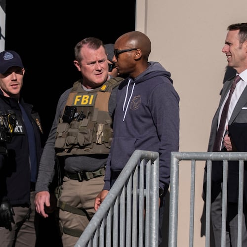 FBI agents are seen at the Fulton County Election Hub and Operation Center, Wednesday, Jan. 28, 2026, in Union City, Ga, near Atlanta. (AP Photo/Mike Stewart)
