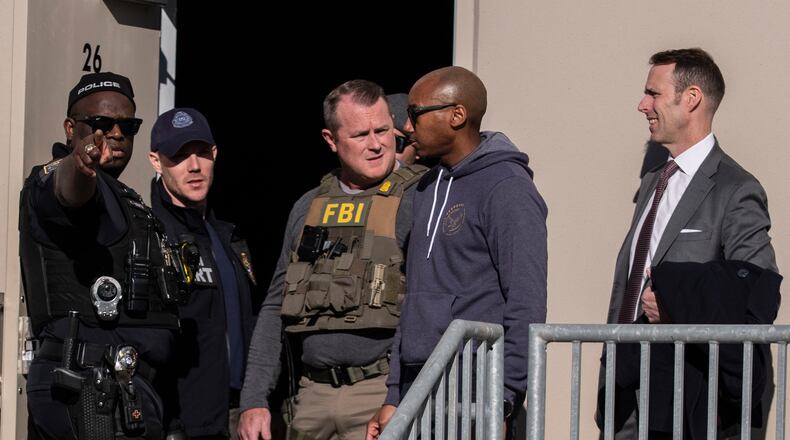 FBI agents are seen at the Fulton County Election Hub and Operation Center, Wednesday, Jan. 28, 2026, in Union City, Ga, near Atlanta. (AP Photo/Mike Stewart)