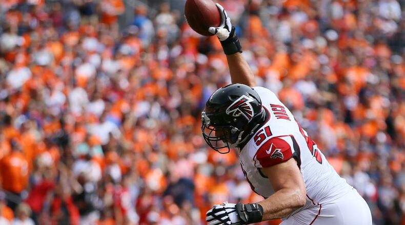 Falcons center Alex Mack spikes the football after Devonta Freeman scored a touchdown in the first quarter Oct. 9, 2016, against the Denver Broncos at Sports Authority Field at Mile High on in Denver.