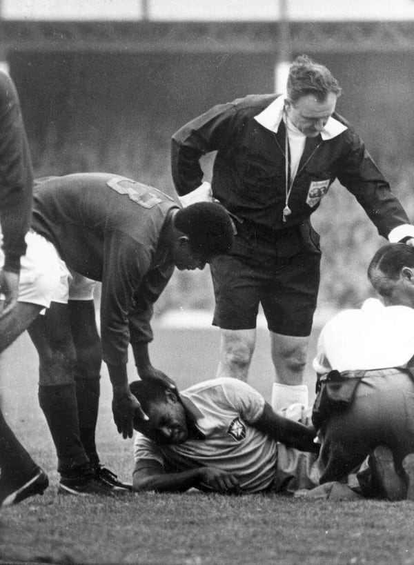 FILE - Brazilian star Pele lies in agony on the ground after being injured in a tackle during the Football World Cup match against Portugal at Goodison Park, Liverpool, on July 19, 1966. (AP Photo/Bippa)