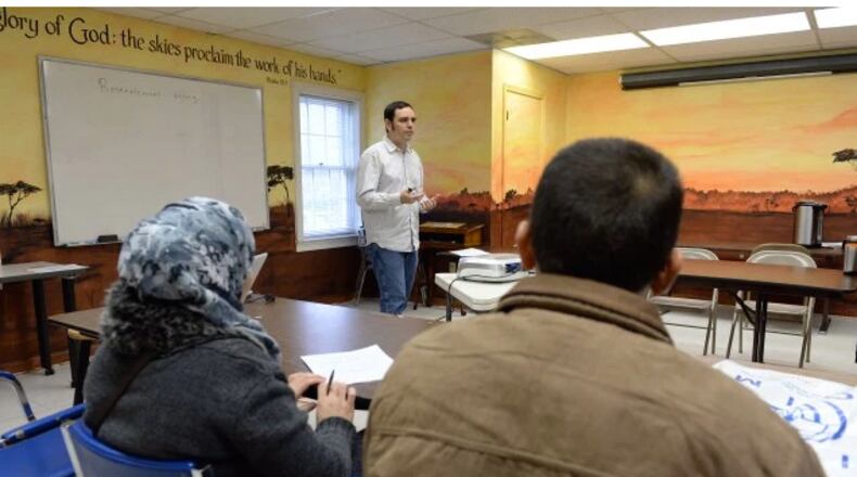 Syrian refugees Mohammad and his wife, Ebtesam listen to David Redd, senior case specialist, during an orientation session. KENT D. JOHNSON/ kdjohnson@ajc.com